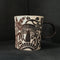 small blackish brown carved porcelain mug