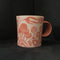 small tangerine carved porcelain mug