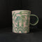 small green carved porcelain mug