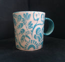 small turquoise carved porcelain mug